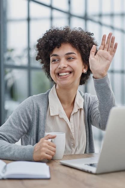 Premium Photo | Woman in the office greeting her colleagues smilling