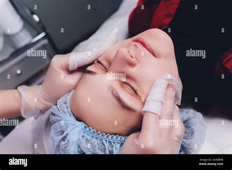 The doctor cosmetologist makes the biorepil facial injections procedure ...