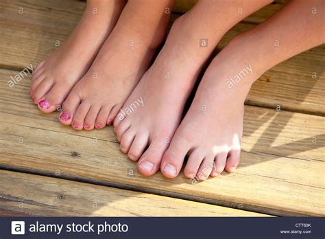 Two Pairs of Girl's Bare Feet, One With Painted Toenails Stock Photo ...