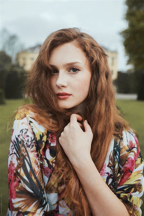 "Portrait Of A Beautiful Young Woman With Freckles And Ginger Hair" by