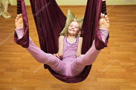 Little girl making aerial yoga exercises, indoor Stock Photo by ...