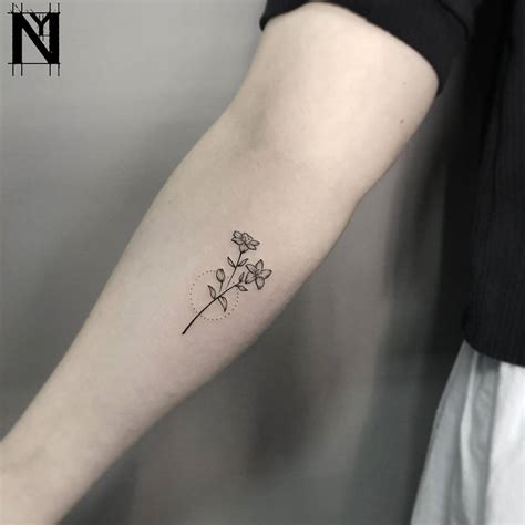 Tiny flower tattoo by Noam Yona - Tattoogrid.net