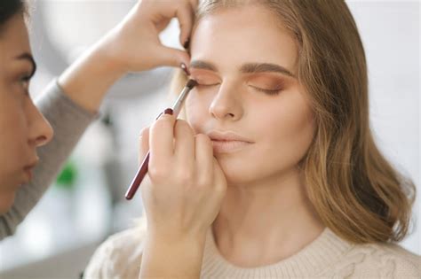 Premium Photo | Model have a makeup by makeup artist in beauty salon ...