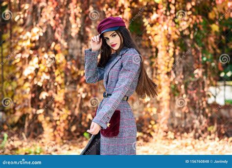 Young Beautiful Girl Wearing Winter Coat and Cap in Autumn Leaves ...