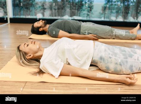 shavasana man  woman wearing  sportswear practice yoga