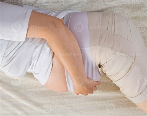 Pregnant girl holding her stomach. Pain and discomfort in pregnant