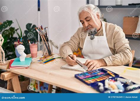 Middle Age Grey-haired Man Artist Drawing Line on Notebook Using Tape Measure at Art Studio ...