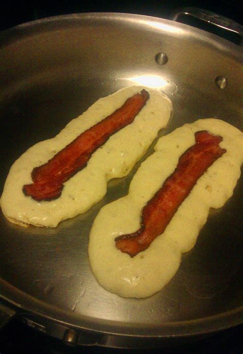 Makin pancakes, makin bacon pancakes, take some bacon and put it in a ...