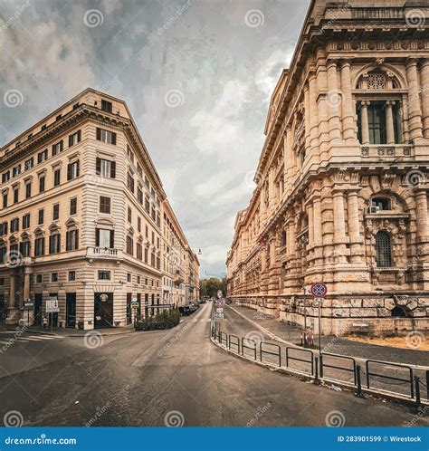 Deserted City Street, Surrounded by Towering Buildings and Illuminated ...