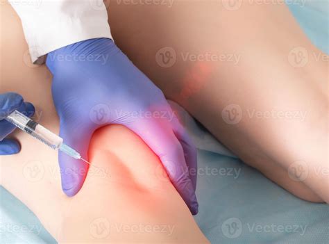 A doctor in the clinic performs a procedure for blocking the tibial