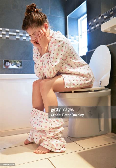 Woman Sitting On Toilet With Head In Hands High-Res Stock Photo - Getty