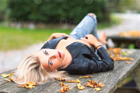 fille nue blonde sexy portant sur un banc en bois en automne 3254361