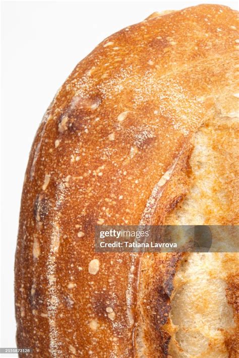 closeup   freshly baked crusty bread loaf   white background