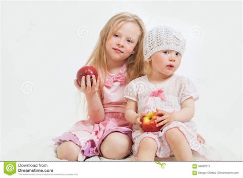 Two little girls sit stock photo. Image of leisure, childhood - 94892312