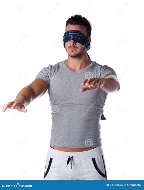 Blindfolded Young Man Feeling His Way In The Dark Stock Photo - Image