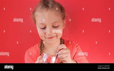 Child eating yogurt jelly pink background. Dairy product diet ...