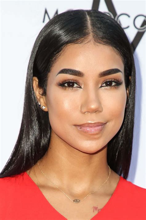 Download Jhene Aiko striking a pose against a floral background