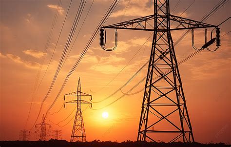 High Voltage Electricity Poles Are In Front Of A Sunset Background ...