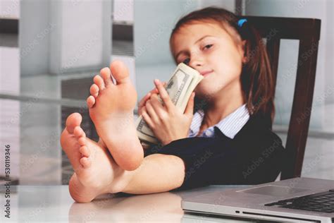 Portrait of very happy cute young business girl with bare feet on the ...