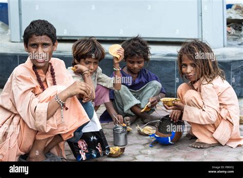 poor homeless children eating   street  amritsar india stock