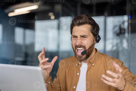 Businessman shows frustration with tech issues during work. Wearing