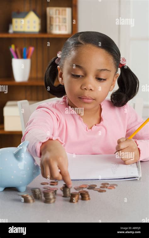 young girl counting coins stock photo alamy