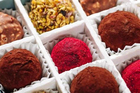 Premium Photo | A set of truffle sweets with different fillings in a ...