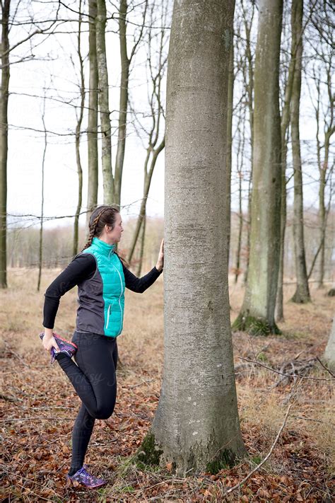 "A Woman Stretching In The Woods Against A Tree" by Stocksy Contributor ...