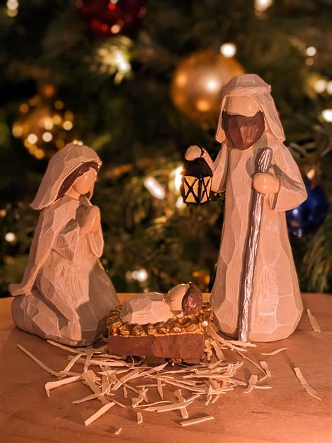 A nativity scene of a manger scene with a baby jesus in a man photo
