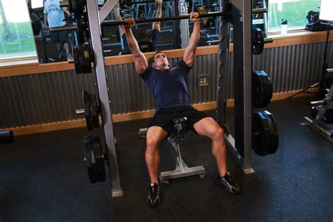 Подъем плеч на наклонной скамье в тренажере Смита | MuscleFit