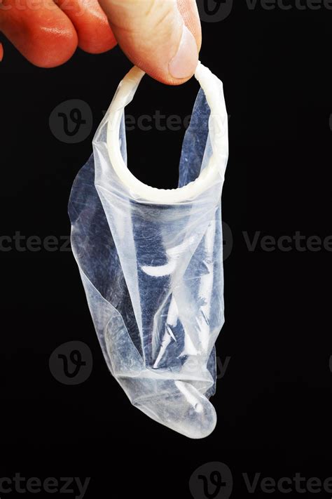 torn white latex condom in hand 9412474 Stock Photo at Vecteezy