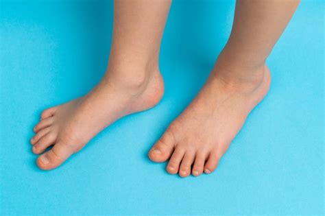 Premium Photo | Children39s feet on a blue background front view the ...