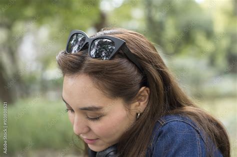 Young women wearing sunglasses on his head Stock Photo | Adobe Stock