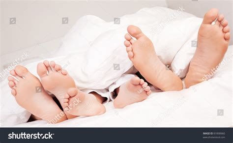Happy Family; Feet Of A Mother ,Father And Their Son Under The Blanket ...