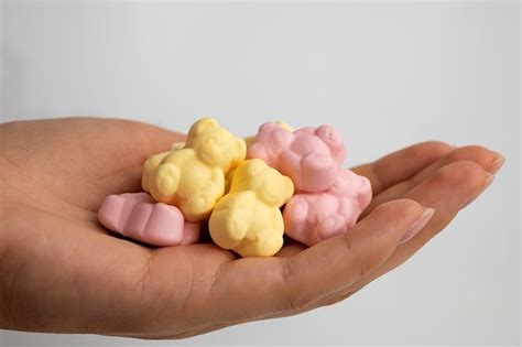 Free Photo | Hand holding delicious gummy bear candy