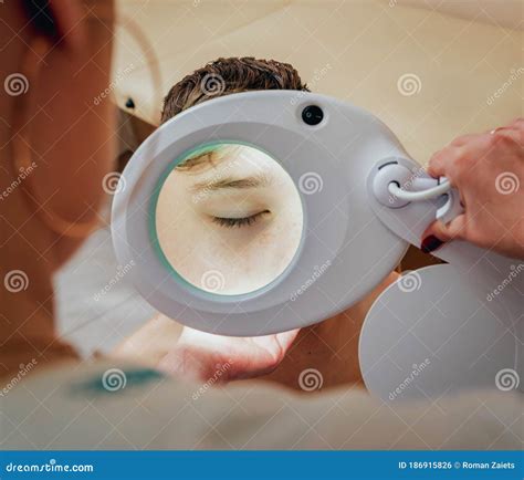 Concentrated Dermatologist Using Medical Loupe in the Clinic Stock ...