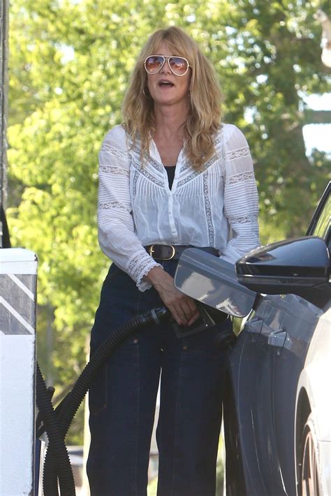 Laura Dern in Wide-legged Dark Denim Jeans and a White Blouse Pumping