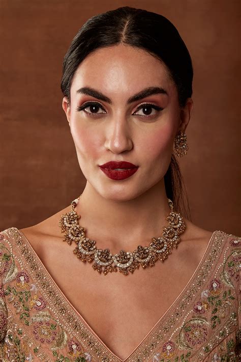 Gold Finish Laxmi Motif Temple Necklace Set by EKATHVA JAIPUR at Pernia