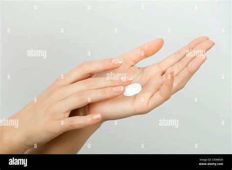Woman moisturizing hands Stock Photo - Alamy