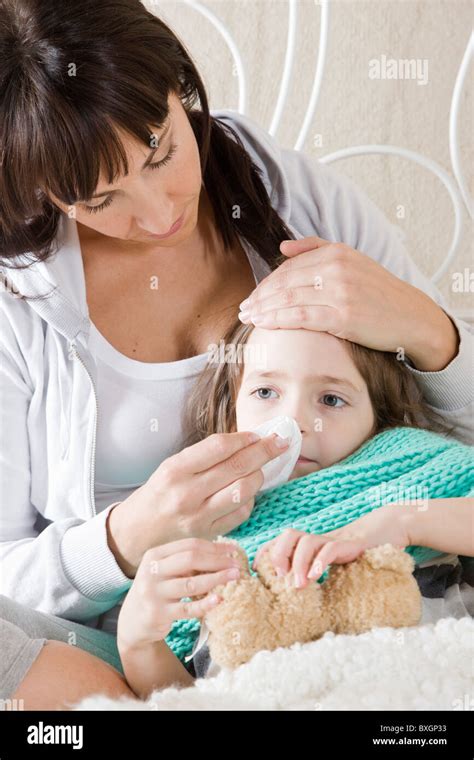 Mother taking care of sick daughter Stock Photo - Alamy