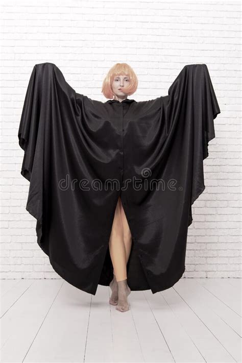 Dancing in Cloak. Girl with Long Fit Legs in Orange Tights Dancing